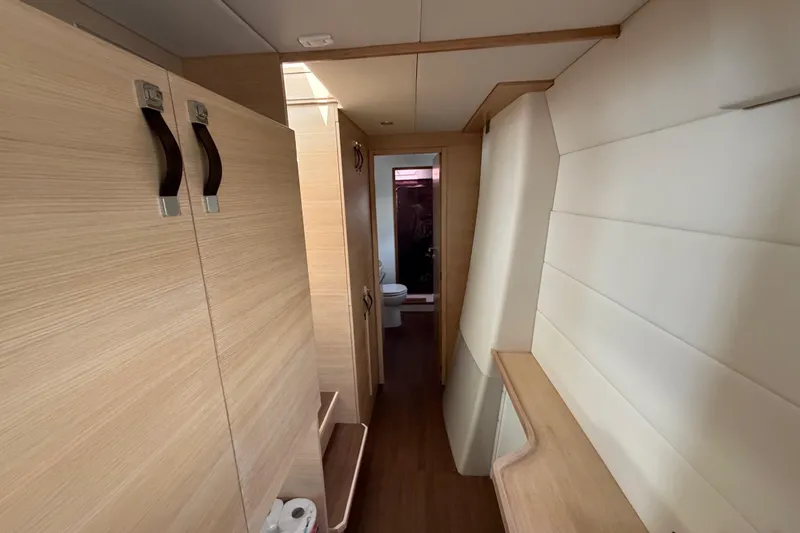 Slide: The Image of Interior hallway of 2025 C-Catamarans 48, featuring modern wood finishes and compact design. - 31