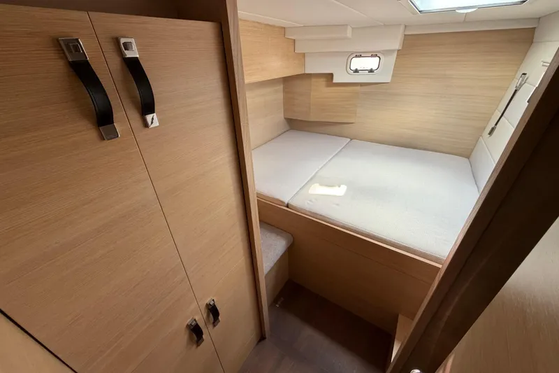 Slide: The Image of 2025 C-Catamarans 48 interior cabin with bed and wooden storage. - 39