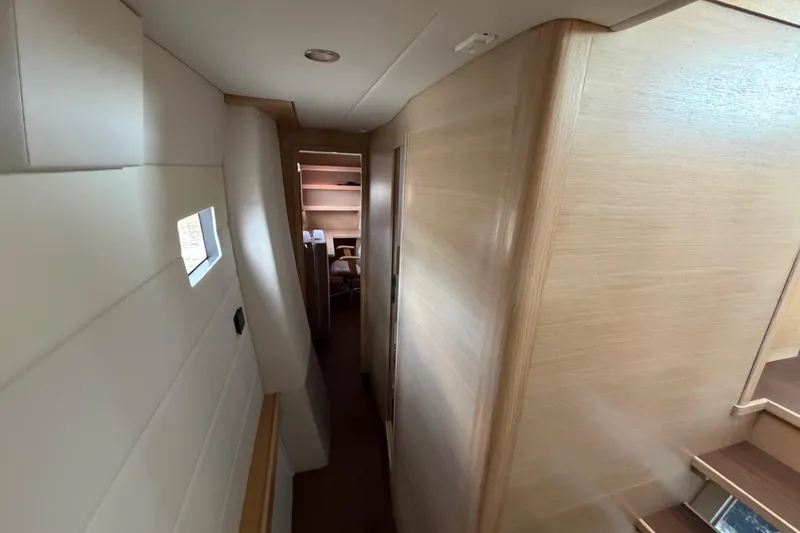 Slide: The Image of Interior hallway of 2025 C-Catamarans 48, featuring modern wood paneling and compact design. - 42