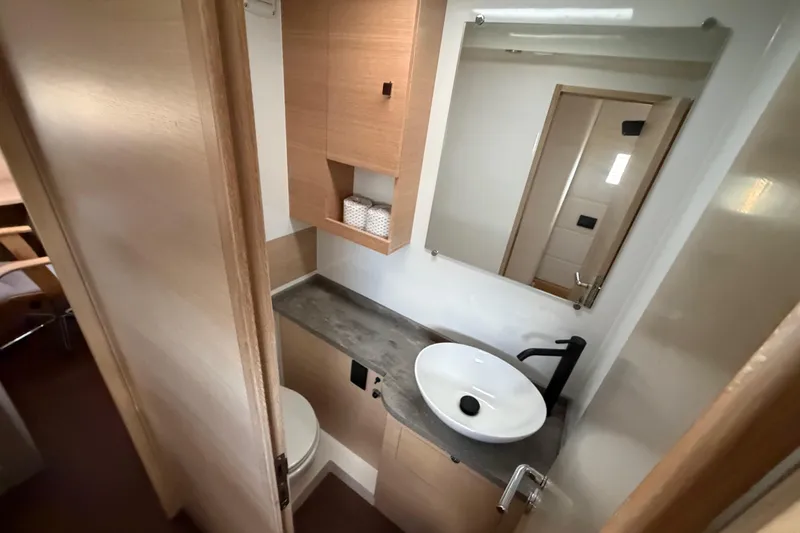 Slide: The Image of Modern bathroom in 2025 C-Catamarans 48, featuring sleek sink and wooden cabinetry. - 43