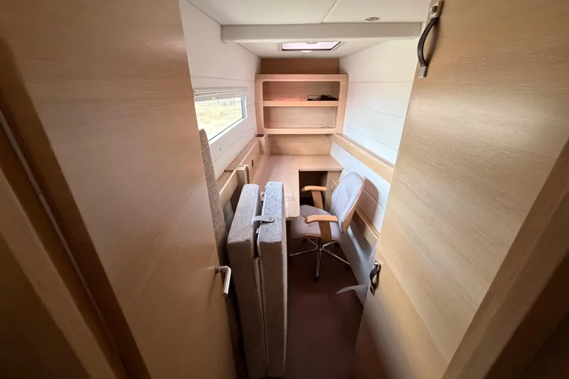 Slide: The Image of Modern interior of 2025 C-Catamarans 48 with desk, chair, and shelving. - 45