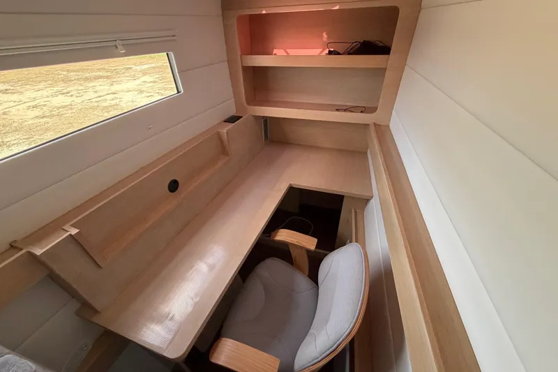 Slide: The Image of Modern interior workspace on 2025 C-Catamarans 48, featuring wooden desk and shelves. - 46