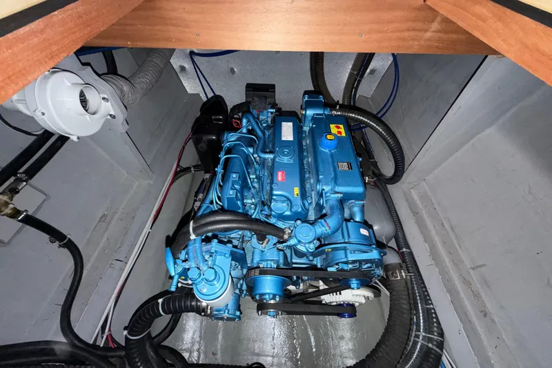 Slide: The Image of Engine compartment of 2025 C-Catamarans 48, featuring a blue marine engine. - 53