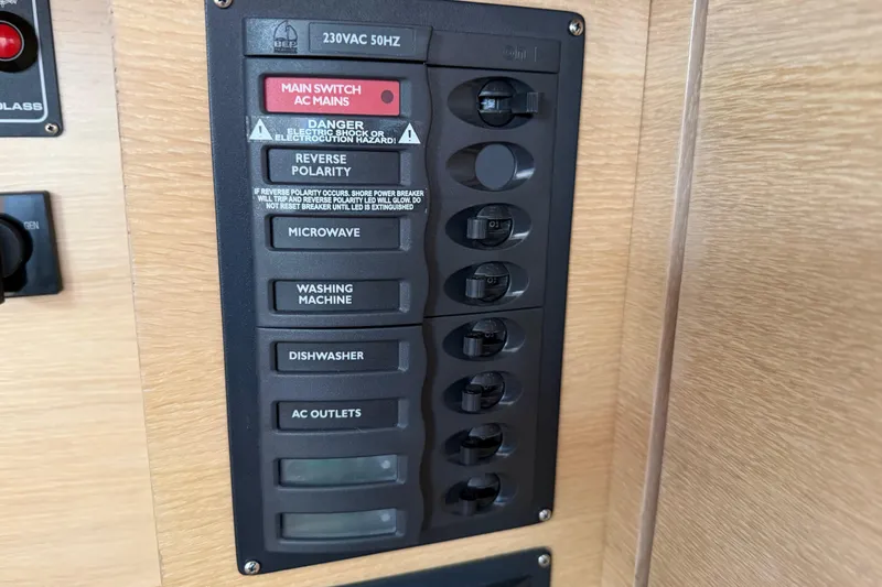 Slide: The Image of Electrical panel on 2025 C-Catamarans 48, featuring switches for various appliances. - 60
