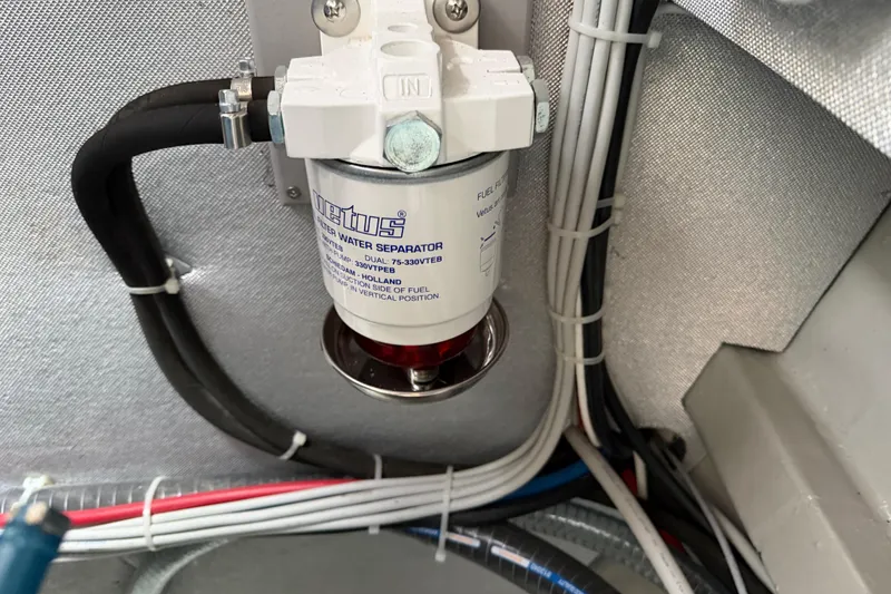 Slide: The Image of Fuel water separator in 2025 C-Catamarans 48 engine room with wiring and hoses. - 73