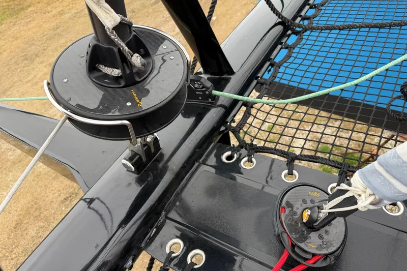 Slide: The Image of C-Catamarans 48 (2025) deck detail with rigging and netting. - 84