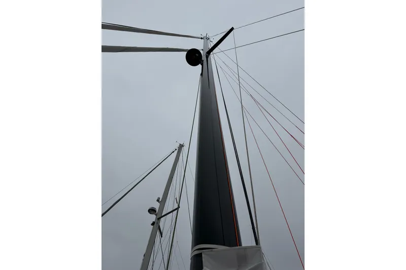 Slide: The Image of Mast of 2025 C-Catamarans 48 against cloudy sky, showcasing rigging details. - 86