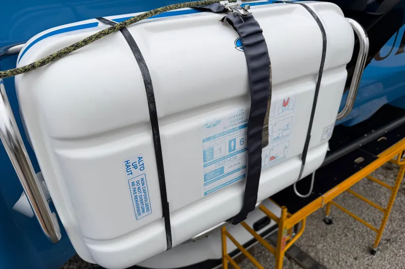 Slide: The Image of Life raft on 2025 C-Catamarans 48, secured with straps, ready for emergency use. - 87