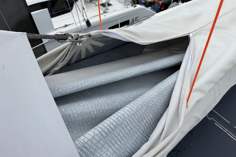 Slide: The Image of 2025 C-Catamarans 48 sail detail with protective cover and rigging. - 90