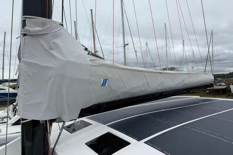 Slide: The Image of 2025 C-Catamarans 48 sailboat with covered mast, docked in a marina under cloudy skies. - 91