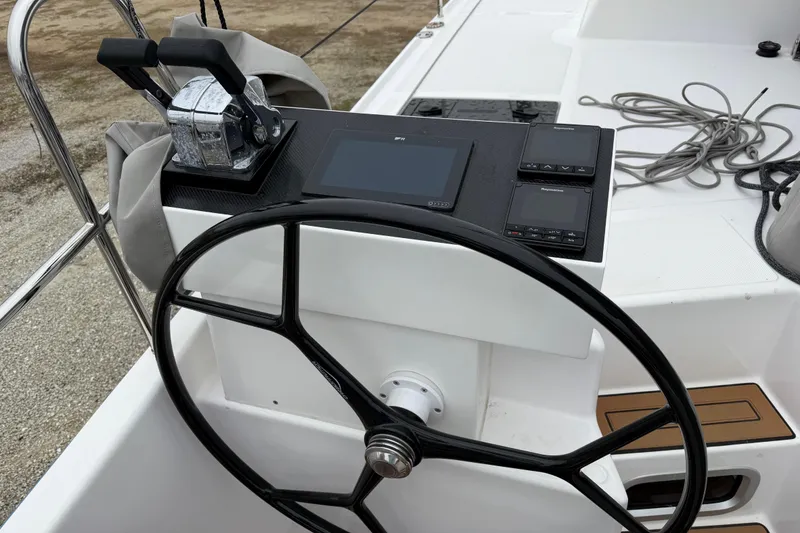 Slide: The Image of Steering wheel and controls of 2025 C-Catamarans 48, featuring modern navigation equipment. - 94