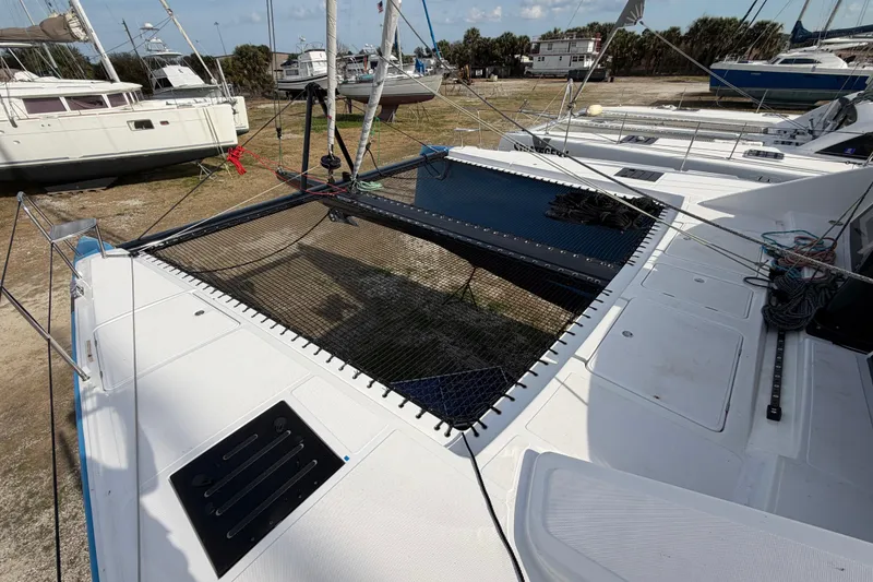 Slide: The Image of 2025 C-Catamarans 48 on land, showcasing deck and netting features. - 99