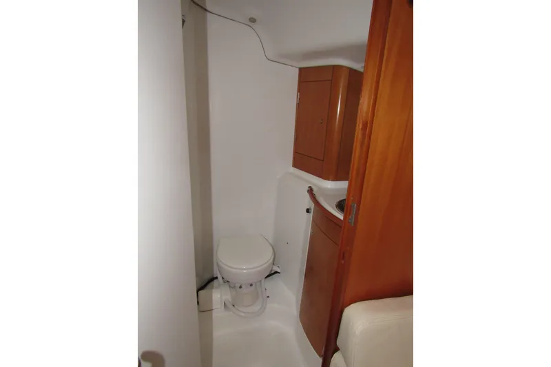 Slide: The Image of 2002 Beneteau First 40.7 yacht bathroom with wooden cabinetry and compact design. - 11