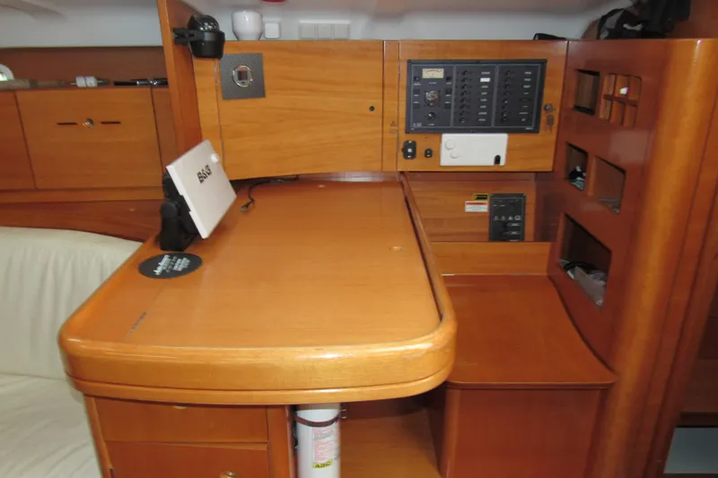 Slide: The Image of Interior of 2002 Beneteau First 40.7 yacht with navigation station and control panel. - 12