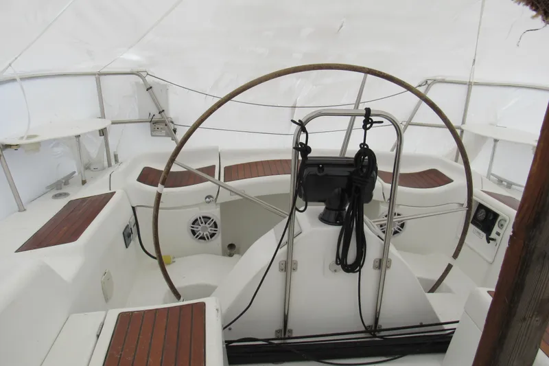 Slide: The Image of Cockpit of 2002 Beneteau First 40.7 sailboat with wooden accents and steering wheel. - 17