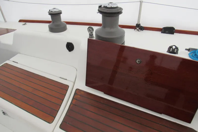 Slide: The Image of Beneteau First 40.7 yacht deck, featuring winches and wooden seating, 2002 model. - 18