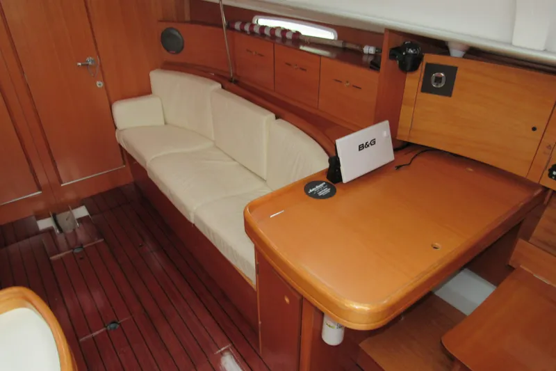 Slide: The Image of Interior of 2002 Beneteau First 40.7 yacht with wooden furnishings and white seating. - 2