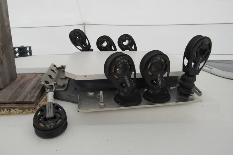 Slide: The Image of Deck hardware on a 2002 Beneteau First 40.7 sailboat, featuring multiple pulleys and rigging components. - 33