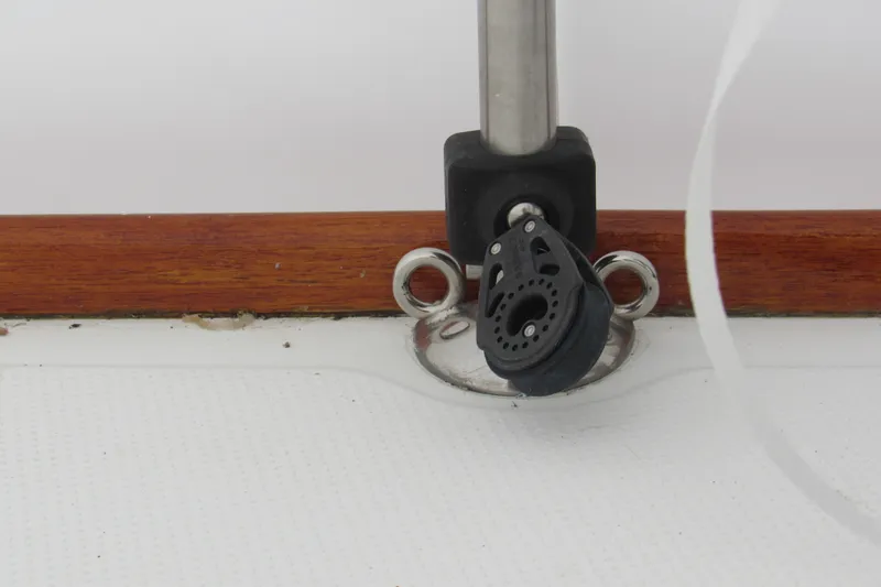Slide: The Image of Deck fitting on a 2002 Beneteau First 40.7 sailboat, featuring a pulley and metal rings. - 34