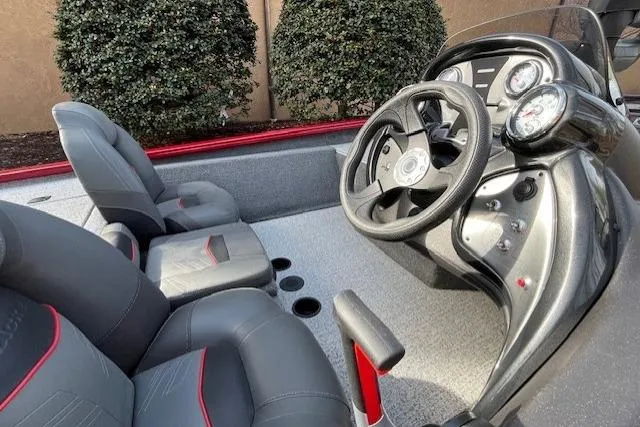 Slide: The Image of 2024 Tracker Pro Team 175 TXW boat interior with steering wheel and seats. - 4
