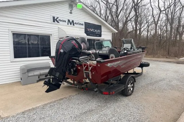 Slide: The Image of 2017 Ranger VS1780 boat at Knox Marine dealership, red exterior, parked on gravel. - 2