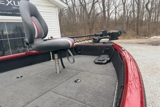 Slide: The Image of 2017 Ranger VS1780 boat with a gray seat and trolling motor, parked outdoors. - 5