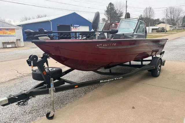 Slide: The Image of 2017 Ranger VS1780 boat on trailer, parked outdoors near blue building. - 9