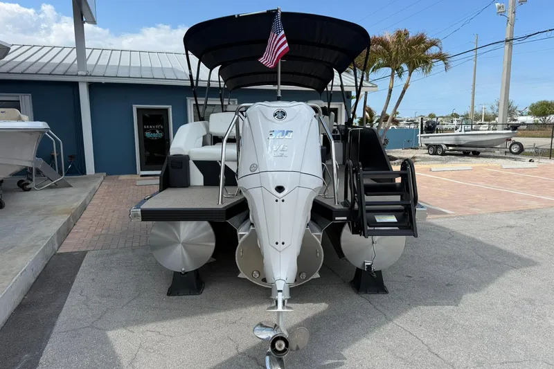 Slide: The Image of Evotti 725CS 2026 boat with powerful engine and American flag, docked at marina. - 2