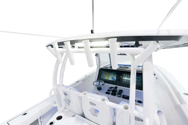 Slide: The Image of Manufacturer Provided Image: 2025 Sportsman Open 352 Center Console boat interior with rod holders and control panel. - 12