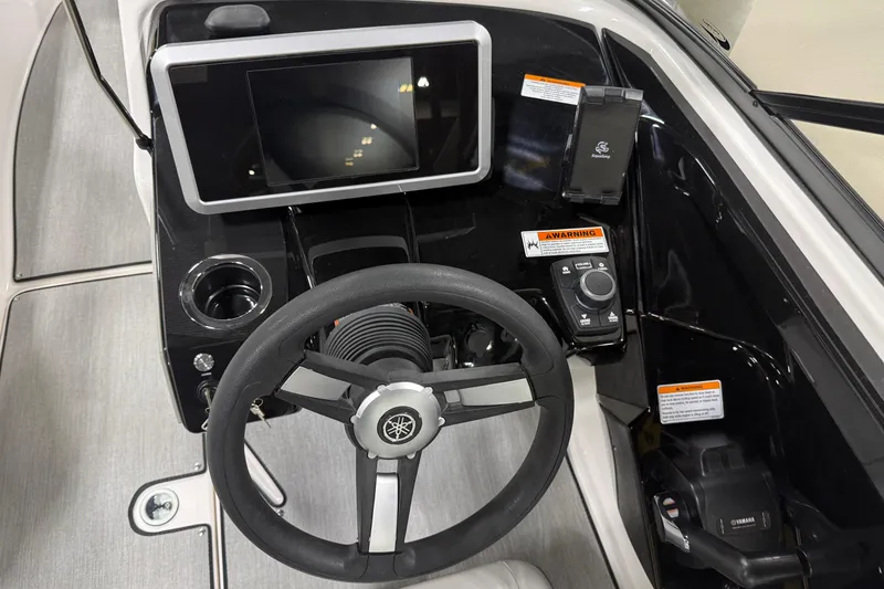 Slide: The Image of 2026 Yamaha Boats AR250 dashboard with steering wheel, touchscreen, and control panel. - 4