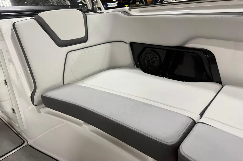 Slide: The Image of 2026 Yamaha Boats AR250 interior seating with sleek, modern design and integrated speaker. - 7