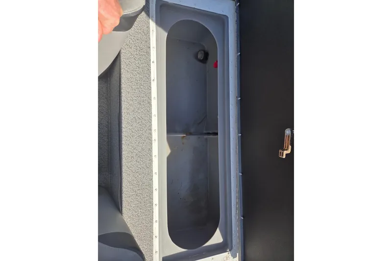 Slide: The Image of 2020 G3 Sportsman 1810 boat storage compartment with open lid, showing interior space. - 12
