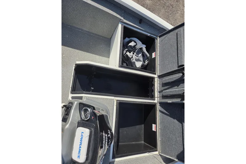 Slide: The Image of 2020 G3 Sportsman 1810 boat storage compartments with Lowrance equipment visible. - 13