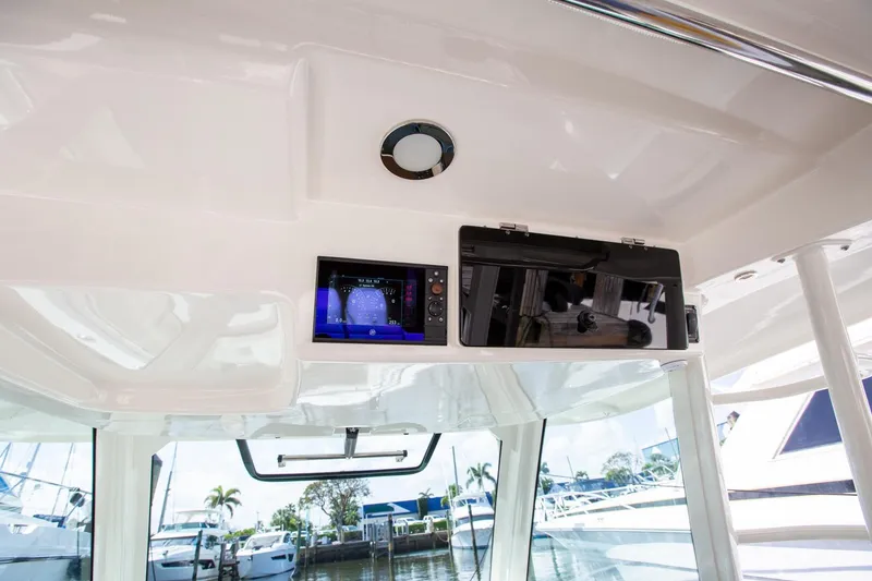 Slide: The Image of 2019 Boston Whaler 380 Outrage interior with navigation display and storage compartment. - 10