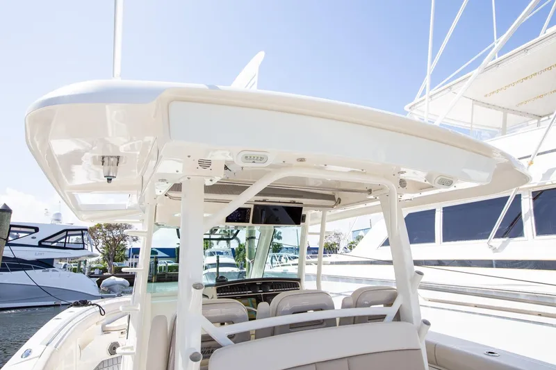 Slide: The Image of 2019 Boston Whaler 380 Outrage boat interior, featuring helm and seating area. - 11