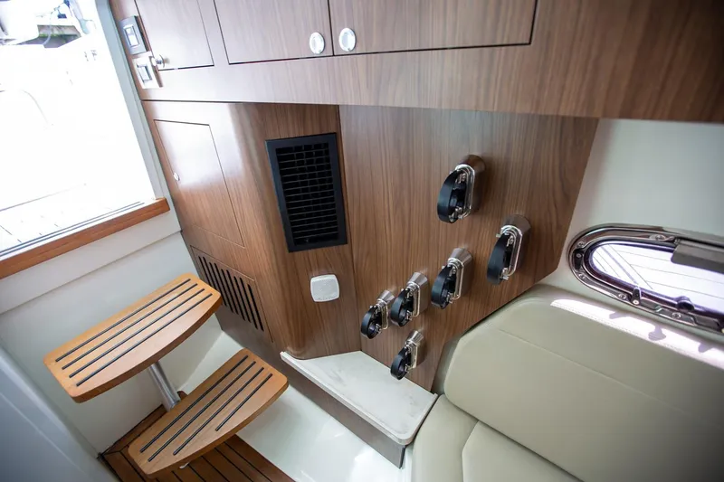 Slide: The Image of Interior of 2019 Boston Whaler 380 Outrage, featuring wooden cabinetry and seating. - 16