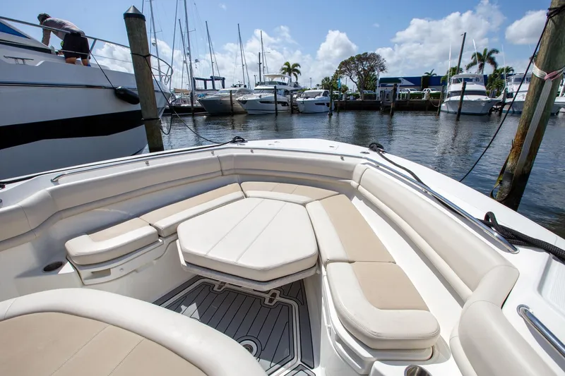 Slide: The Image of 2019 Boston Whaler 380 Outrage boat interior with cushioned seating at marina. - 5