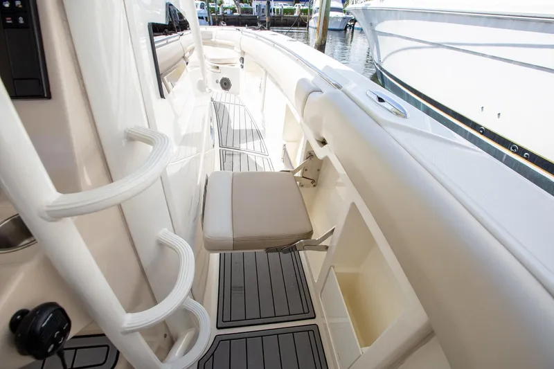 Slide: The Image of 2019 Boston Whaler 380 Outrage interior with seating and storage compartments. - 7