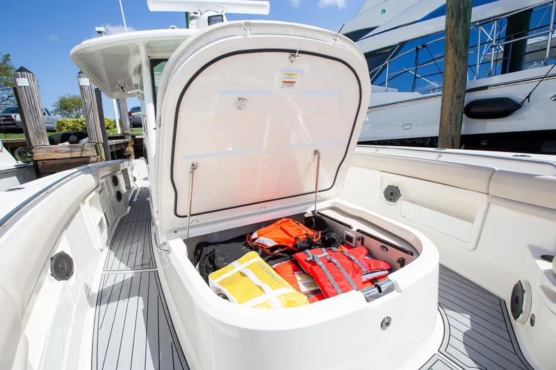 Slide: The Image of 2019 Boston Whaler 380 Outrage boat storage compartment with life jackets and safety gear. - 8