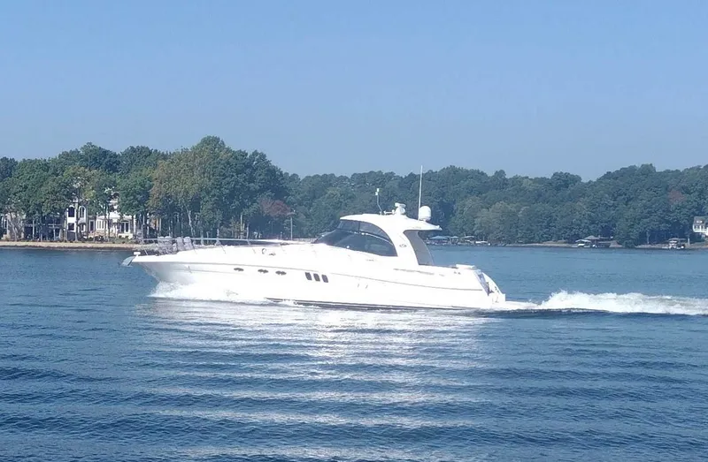 The Image of 2006 Sea Ray 52 Sundancer cruising on a serene lake. - 0