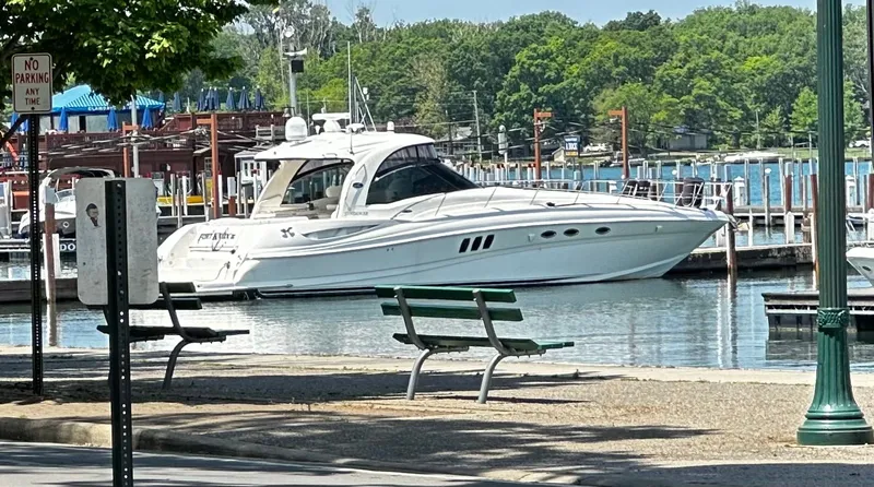 Slide: The Image of 2006 Sea Ray 52 Sundancer docked at marina, surrounded by trees. - 6