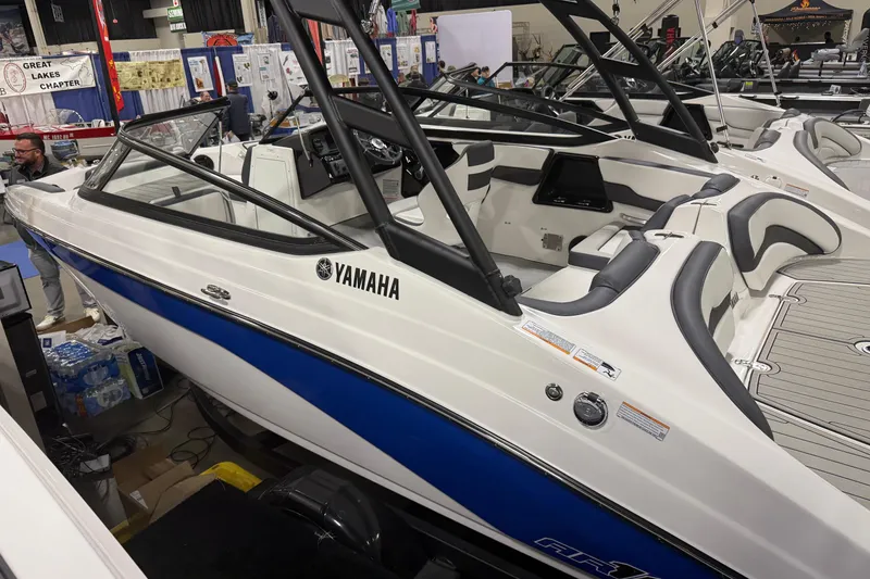 Slide: The Image of 2026 Yamaha Boats AR195 displayed at a boat show, featuring sleek design and modern interior. - 0