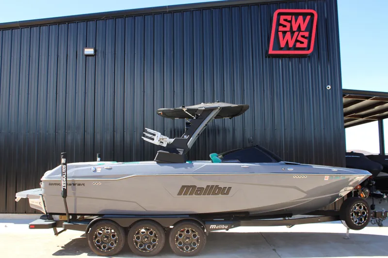 Slide: The Image of 2020 Malibu Wakesetter 25 LSV boat on trailer outside SWWS building. - 1