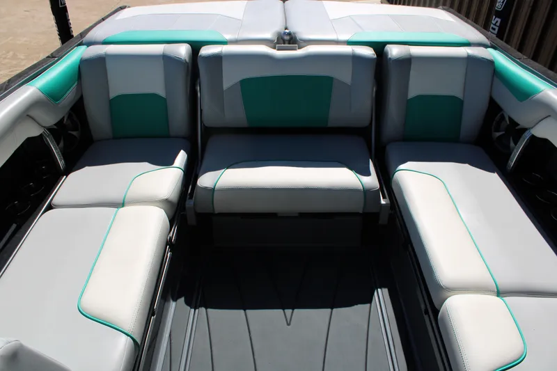 Slide: The Image of 2020 Malibu Wakesetter 25 LSV interior seating with teal and gray upholstery. - 14