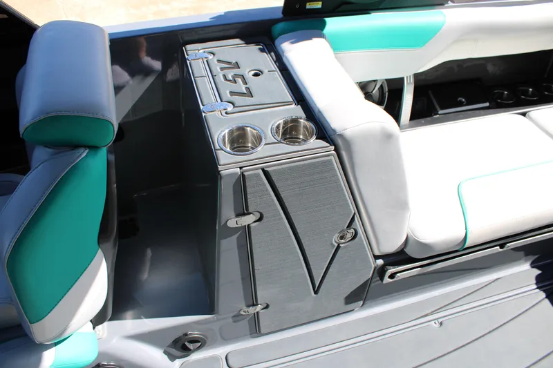 Slide: The Image of 2020 Malibu Wakesetter 25 LSV interior with teal and gray seating, cup holders, and storage. - 18