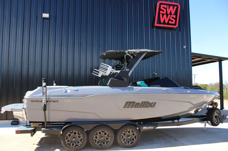 Slide: The Image of 2020 Malibu Wakesetter 25 LSV boat on trailer, parked outside SWWS building. - 5