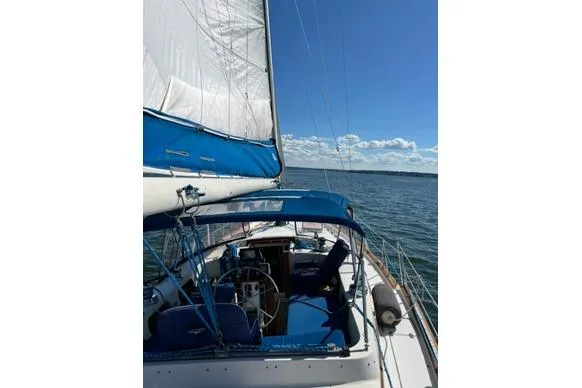 Slide: The Image of 1987 Irwin 43 Mk II Cruiser sailing on open water under clear blue skies. - 10