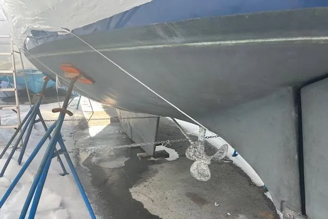 Slide: The Image of 1987 Irwin 43 Mk II Cruiser on stands, showing hull and propeller in a snowy setting. - 14