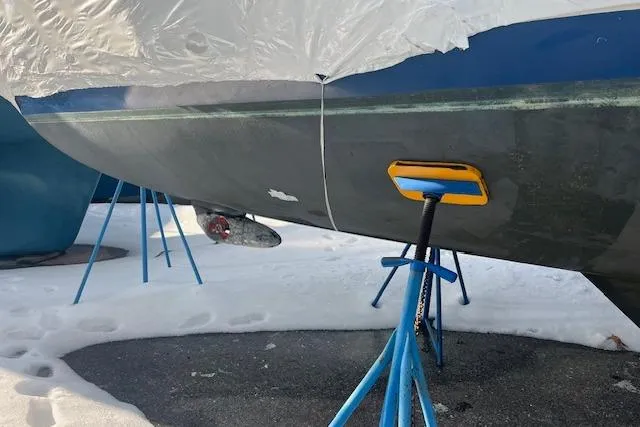 Slide: The Image of 1987 Irwin 43 Mk II Cruiser on stands, partially covered, in snowy setting. - 16