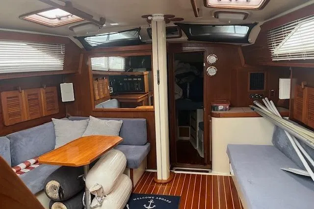 Slide: The Image of Interior of 1987 Irwin 43 Mk II Cruiser with cozy seating and wooden accents. - 2